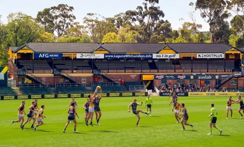 Players Playing Football in Punt Road Oval